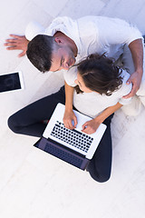 Image showing couple using tablet and laptop computers top view