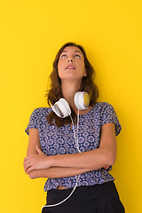 Image showing woman with headphones isolated on a yellow