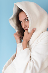 Image showing woman in a white coat with hood isolated on blue background