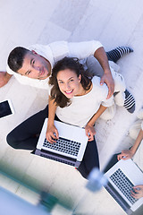 Image showing couple using tablet and laptop computers top view