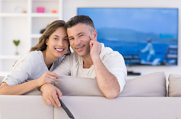 Image showing Young couple on the sofa watching television