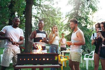 Image showing Group of friends making barbecue in the backyard. concept about good and positive mood with friends