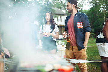 Image showing Group of friends making barbecue in the backyard. concept about good and positive mood with friends