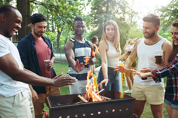 Image showing Group of friends making barbecue in the backyard. concept about good and positive mood with friends