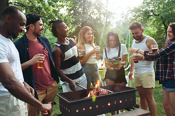 Image showing Group of friends making barbecue in the backyard. concept about good and positive mood with friends