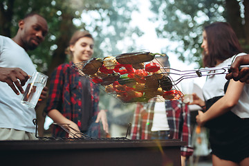 Image showing Group of friends making barbecue in the backyard. concept about good and positive mood with friends