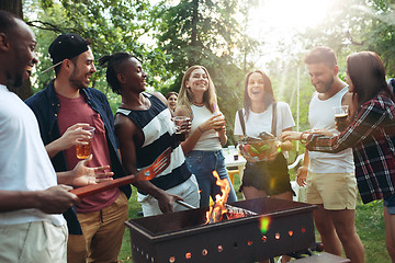 Image showing Group of friends making barbecue in the backyard. concept about good and positive mood with friends