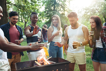 Image showing Group of friends making barbecue in the backyard. concept about good and positive mood with friends