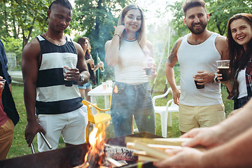 Image showing Group of friends making barbecue in the backyard. concept about good and positive mood with friends