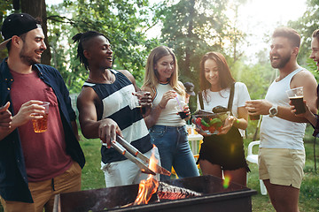 Image showing Group of friends making barbecue in the backyard. concept about good and positive mood with friends