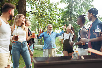 Image showing Group of friends making barbecue in the backyard. concept about good and positive mood with friends