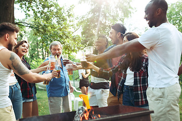 Image showing Group of friends making barbecue in the backyard. concept about good and positive mood with friends