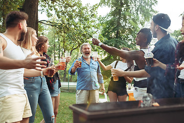 Image showing Group of friends making barbecue in the backyard. concept about good and positive mood with friends