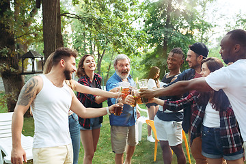 Image showing Group of friends making barbecue in the backyard. concept about good and positive mood with friends