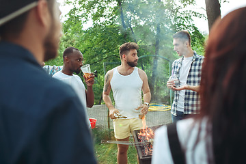 Image showing Group of friends making barbecue in the backyard. concept about good and positive mood with friends