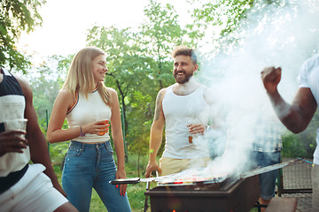 Image showing Group of friends making barbecue in the backyard. concept about good and positive mood with friends