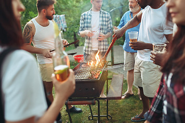 Image showing Group of friends making barbecue in the backyard. concept about good and positive mood with friends