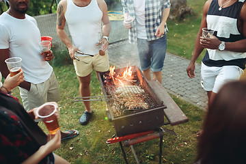 Image showing Group of friends making barbecue in the backyard. concept about good and positive mood with friends