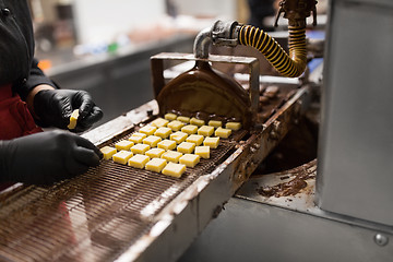 Image showing confectioner with chocolate coating machine