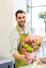 Image showing smiling florist man with bunch at flower shop