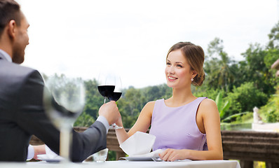 Image showing young couple with glasses of wine at restaurant