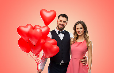 Image showing happy couple with red heart shaped balloons