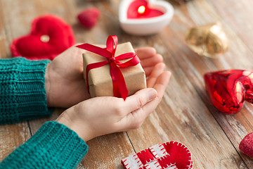 Image showing close up of hands holding christmas gift