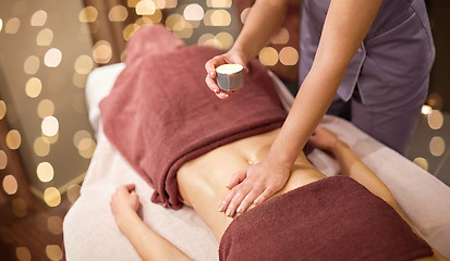 Image showing woman lying and having massage with hot oil at spa