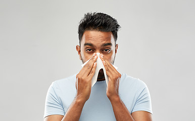 Image showing indian man with paper napkin blowing nose