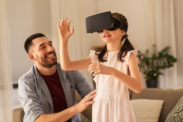 Image showing father and daughter playing video game at home