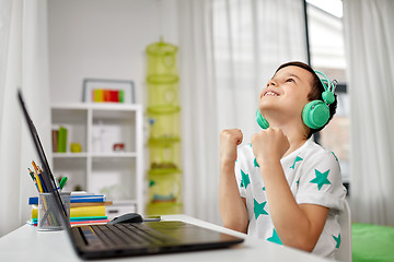 Image showing boy celebrating victory in computer video game