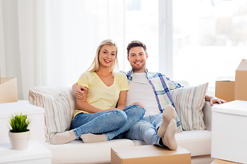 Image showing happy couple with boxes moving to new home