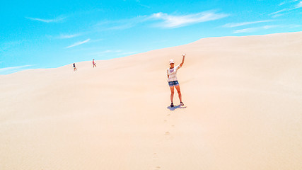 Image showing Aussie woman enjoying the vast sand dunes in summer