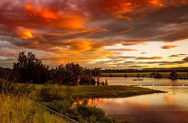 Image showing Sunset sky over rural lakes with mountain backdrop