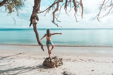 Image showing Girl at idyllic beach in early morning, balance, fitness, freedo