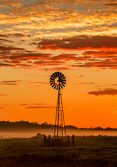 Image showing Windmill and misty morning across rural farmland fields