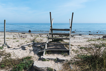 Image showing Wooden stile across a fence by the coast in summertime