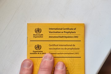 Image showing Vaccination certificate shown at a desk