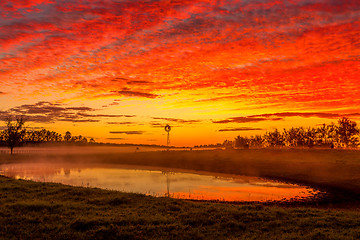 Image showing Blazing red sunrise skies across rural landscape Australia