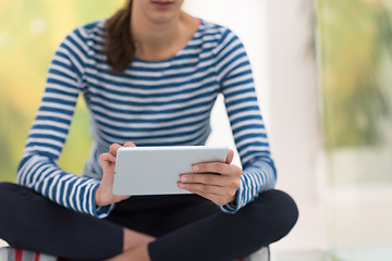 Image showing young women using tablet computer on the floor