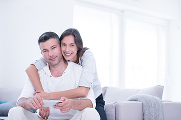 Image showing happy couple using mobile phone at home