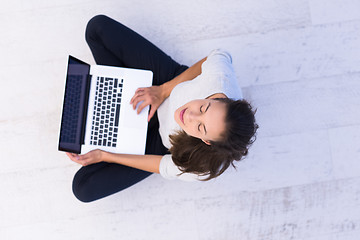 Image showing women using laptop computer on the floor top view