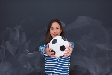 Image showing woman holding a soccer ball in front of chalk drawing board