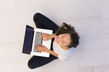 Image showing women using laptop computer on the floor top view