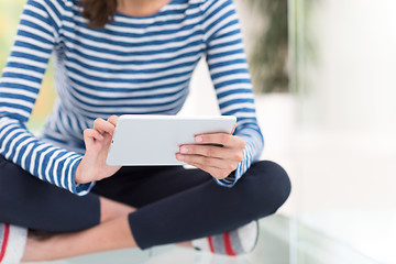 Image showing young women using tablet computer on the floor