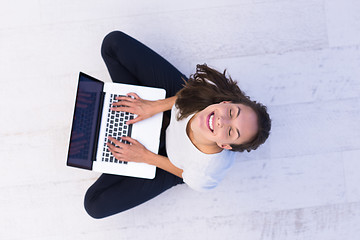 Image showing women using laptop computer on the floor top view