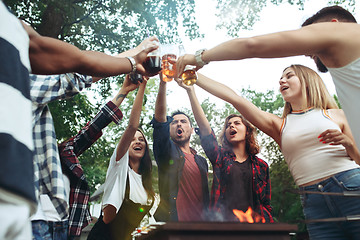 Image showing Group of friends making barbecue in the backyard. concept about good and positive mood with friends