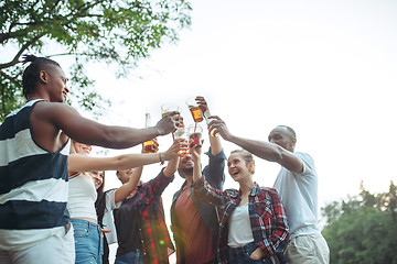 Image showing Group of friends making barbecue in the backyard. concept about good and positive mood with friends