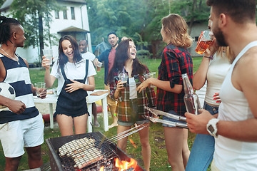 Image showing Group of friends making barbecue in the backyard. concept about good and positive mood with friends