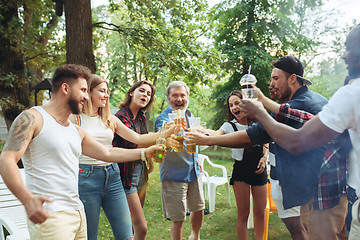 Image showing Group of friends making barbecue in the backyard. concept about good and positive mood with friends